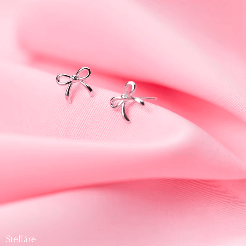 Sterling silver stud earrings in delicate bow shape – dainty knot design symbolising connection and elegance