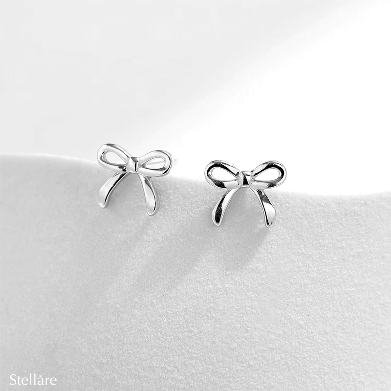 Sterling silver stud earrings in delicate bow shape – dainty knot design symbolising connection and elegance