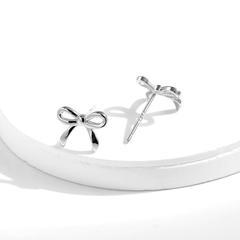 Sterling silver stud earrings in delicate bow shape – dainty knot design symbolising connection and elegance