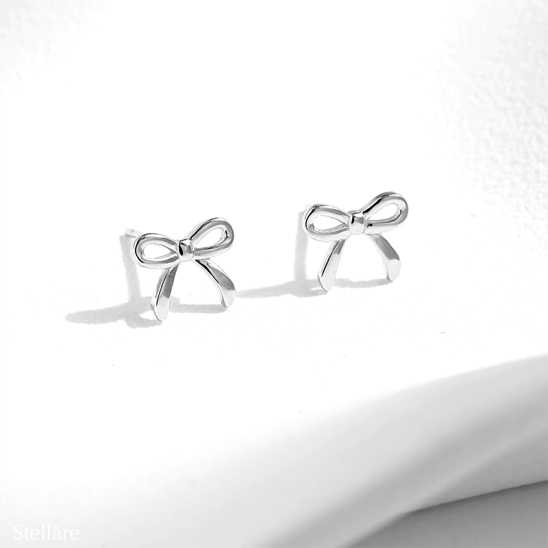 Sterling silver stud earrings in delicate bow shape – dainty knot design symbolising connection and elegance