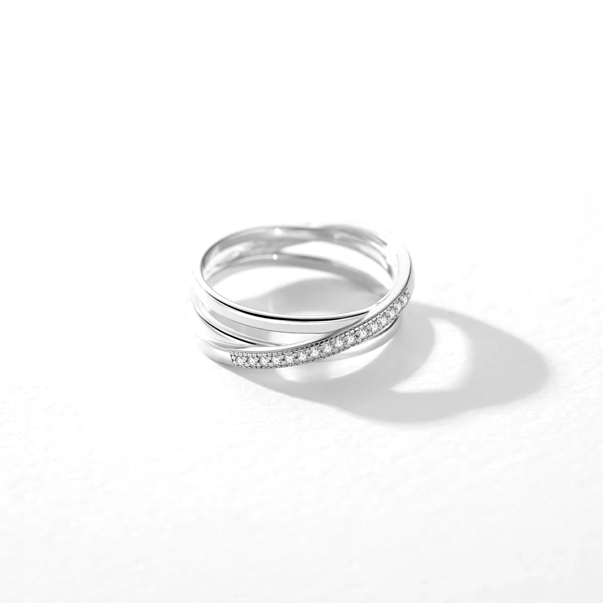 Sterling silver intertwined band ring – twisted pavé and polished design for elegant everyday wear