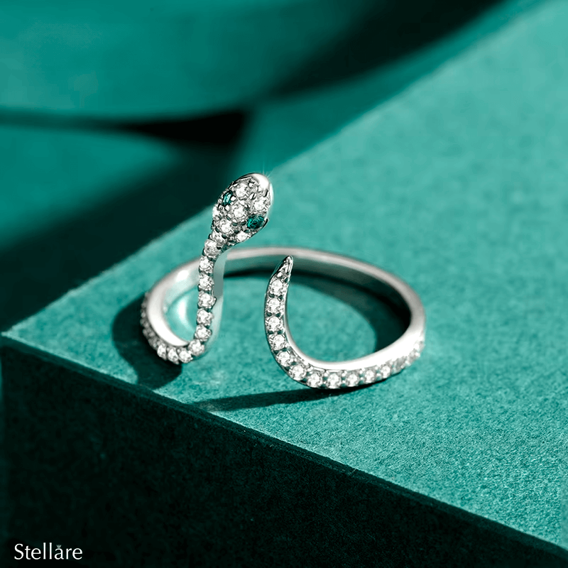 Sterling silver snake ring with pavé zirconia and green stone eyes – bold, symbolic and adjustable design