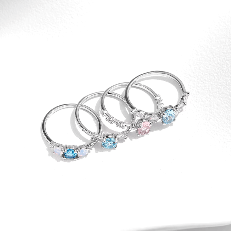Colorful 925 sterling silver gemstone rings with heart, round, and baguette stones, worn in combination or shown individually