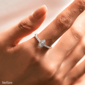 Sterling silver ring with marquise-cut zirconia centerpiece and pavé band, photographed in elegant settings and on hand.