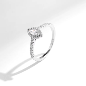 Sterling silver ring with marquise-cut zirconia centerpiece and pavé band, photographed in elegant settings and on hand.