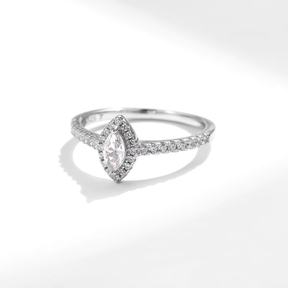 Sterling silver ring with marquise-cut zirconia centerpiece and pavé band, photographed in elegant settings and on hand.