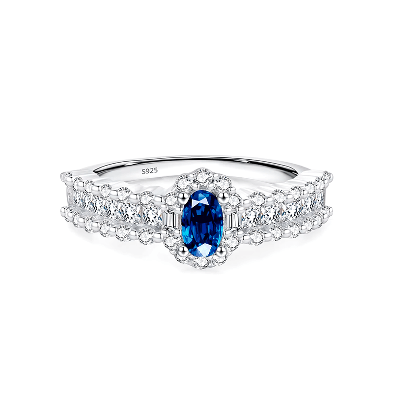 925 sterling silver ring featuring a deep blue oval sapphire and a triple row of shimmering zirconia stones, styled on hand and in detail