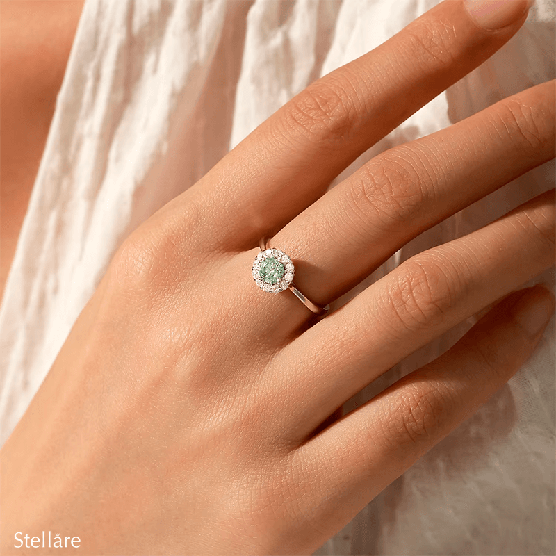 925 sterling silver ring featuring an ocean-blue centre stone encircled by brilliant white zirconia, shown on model and close-up