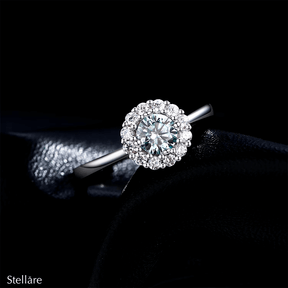 925 sterling silver ring featuring an ocean-blue centre stone encircled by brilliant white zirconia, shown on model and close-up