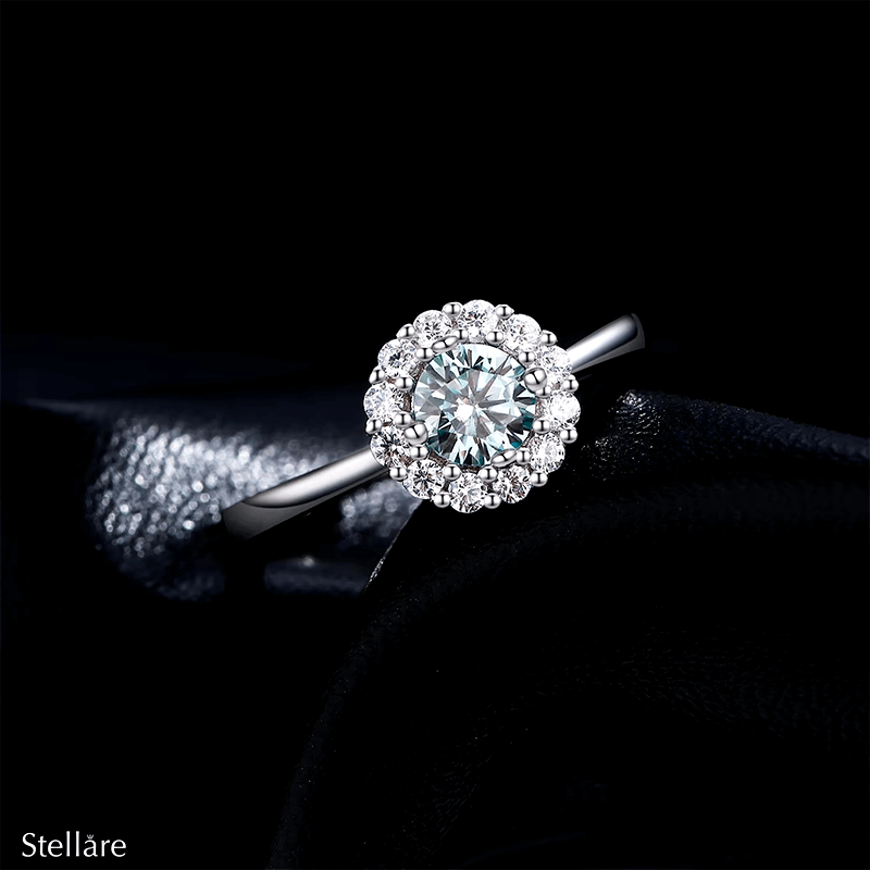 925 sterling silver ring featuring an ocean-blue centre stone encircled by brilliant white zirconia, shown on model and close-up
