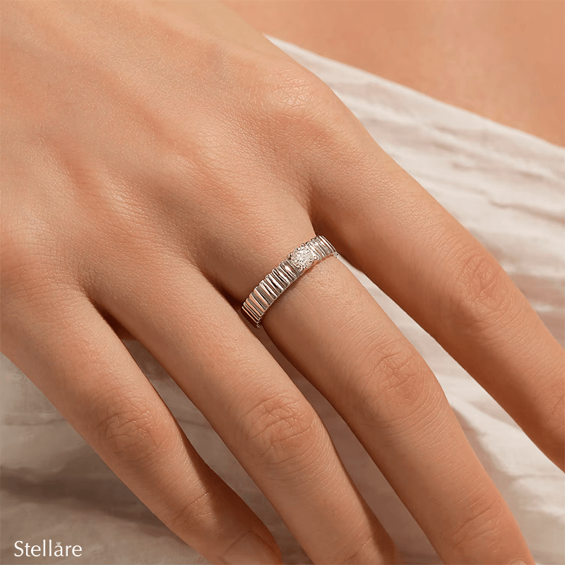 925 sterling silver ring with modern vertical grooves and center zirconia, shown on hand and in close-up with soft black background.