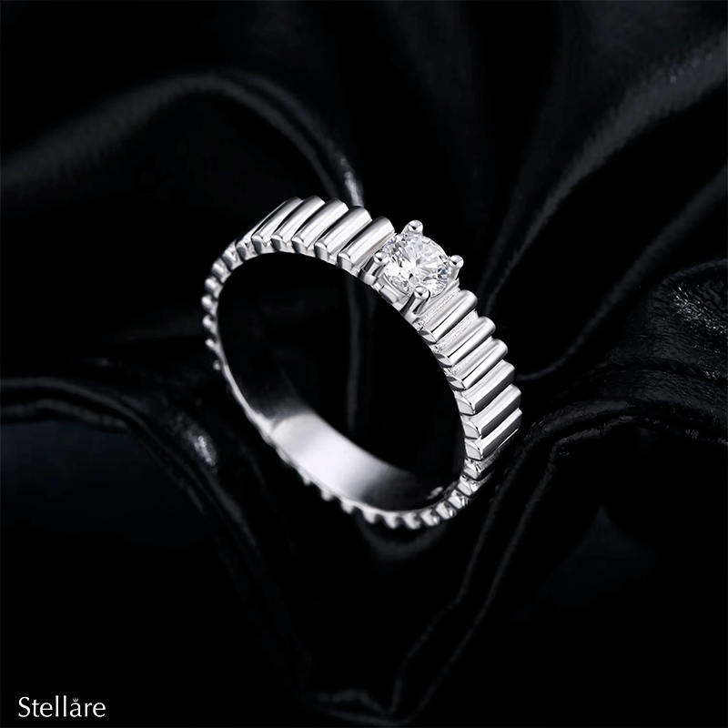 925 sterling silver ring with modern vertical grooves and center zirconia, shown on hand and in close-up with soft black background.