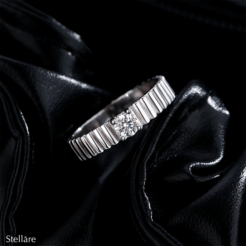 925 sterling silver ring with modern vertical grooves and center zirconia, shown on hand and in close-up with soft black background.