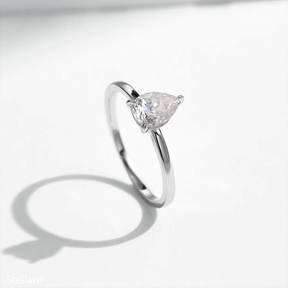 925 silver ring featuring a pear-shaped zirconia stone in a minimalist setting, displayed on hand and in close-up product views