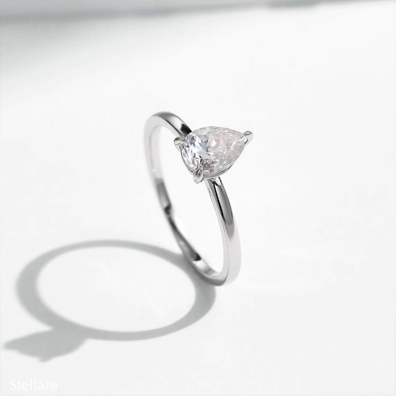 925 silver ring featuring a pear-shaped zirconia stone in a minimalist setting, displayed on hand and in close-up product views