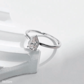 925 silver ring featuring a pear-shaped zirconia stone in a minimalist setting, displayed on hand and in close-up product views