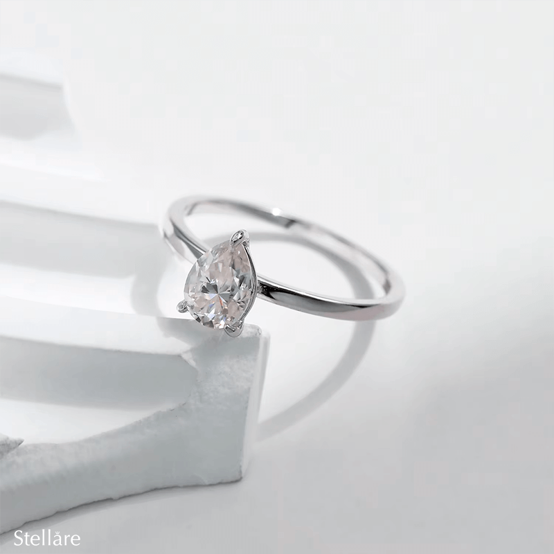925 silver ring featuring a pear-shaped zirconia stone in a minimalist setting, displayed on hand and in close-up product views