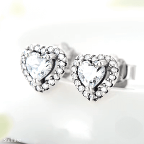 Sterling silver stud earrings with brilliant heart-shaped zirconia and halo setting – romantic and elegant design