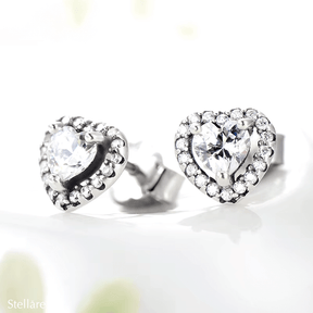 Sterling silver stud earrings with brilliant heart-shaped zirconia and halo setting – romantic and elegant design