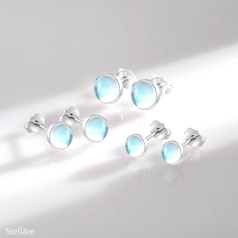 Sterling silver stud earrings with luminous blue stones – celestial-inspired design for elegance and serenity