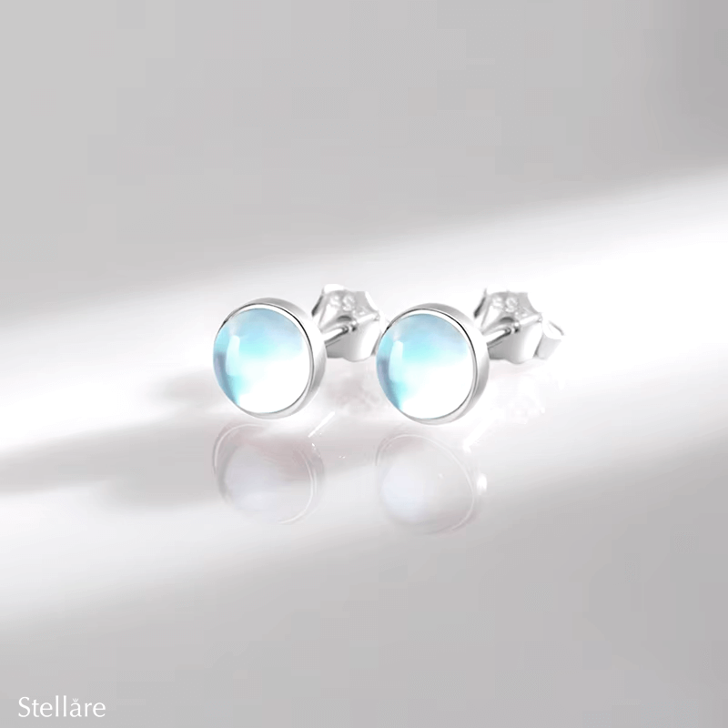 Sterling silver stud earrings with luminous blue stones – celestial-inspired design for elegance and serenity