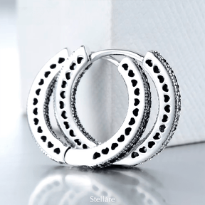 Sterling silver hoop earrings with heart-cut details and zirconia – symbolic, stylish and elegant design for everyday or gifting