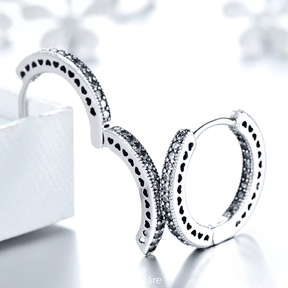 Sterling silver hoop earrings with heart-cut details and zirconia – symbolic, stylish and elegant design for everyday or gifting
