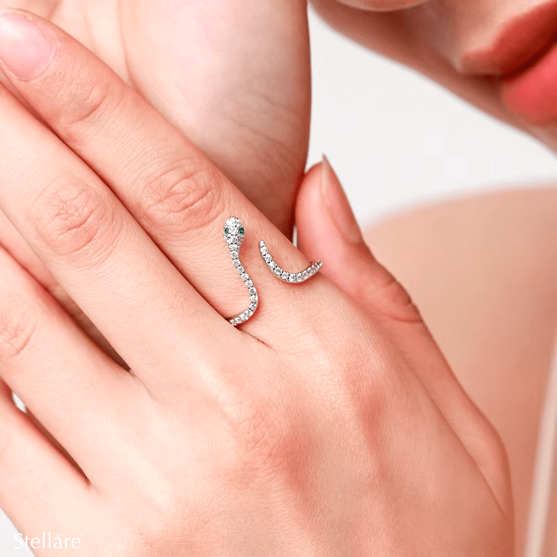Sterling silver snake ring with pavé zirconia and green stone eyes – bold, symbolic and adjustable design