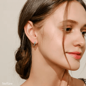 Sterling silver hoop earrings with turquoise stones and central blue charm – elegant and vibrant for stylish everyday wear