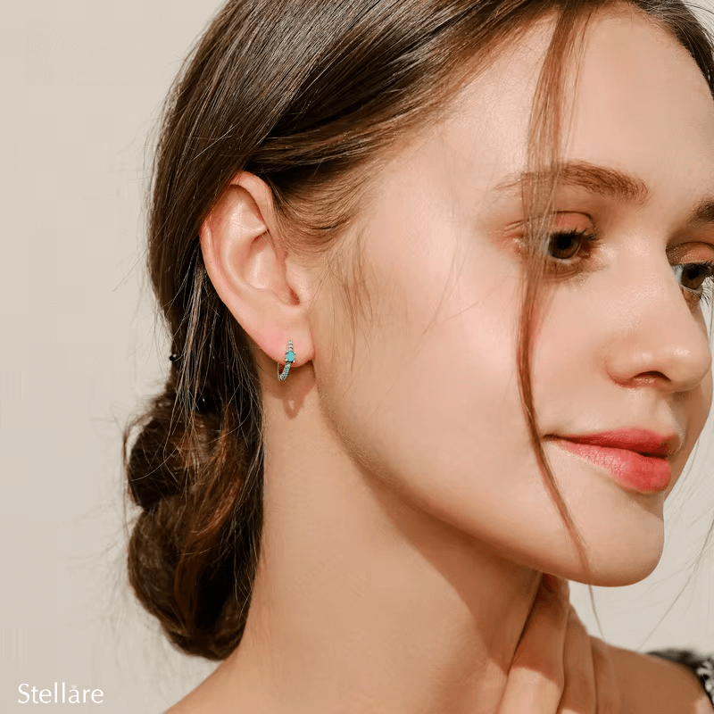 Sterling silver hoop earrings with turquoise stones and central blue charm – elegant and vibrant for stylish everyday wear