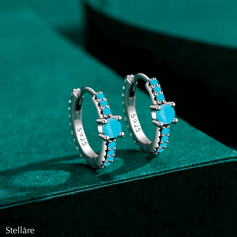 Sterling silver hoop earrings with turquoise stones and central blue charm – elegant and vibrant for stylish everyday wear