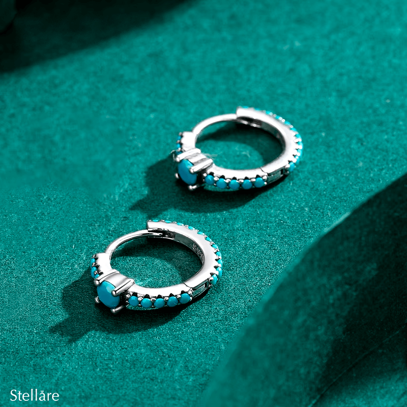Sterling silver hoop earrings with turquoise stones and central blue charm – elegant and vibrant for stylish everyday wear